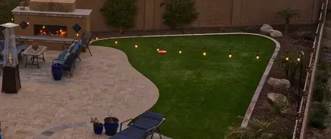 Weed free manicured lawn and landscape beds with refreshed rock in Mesilla, MN