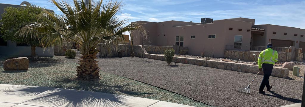 Professional maintaining rock landscaping in El Paso, TX.